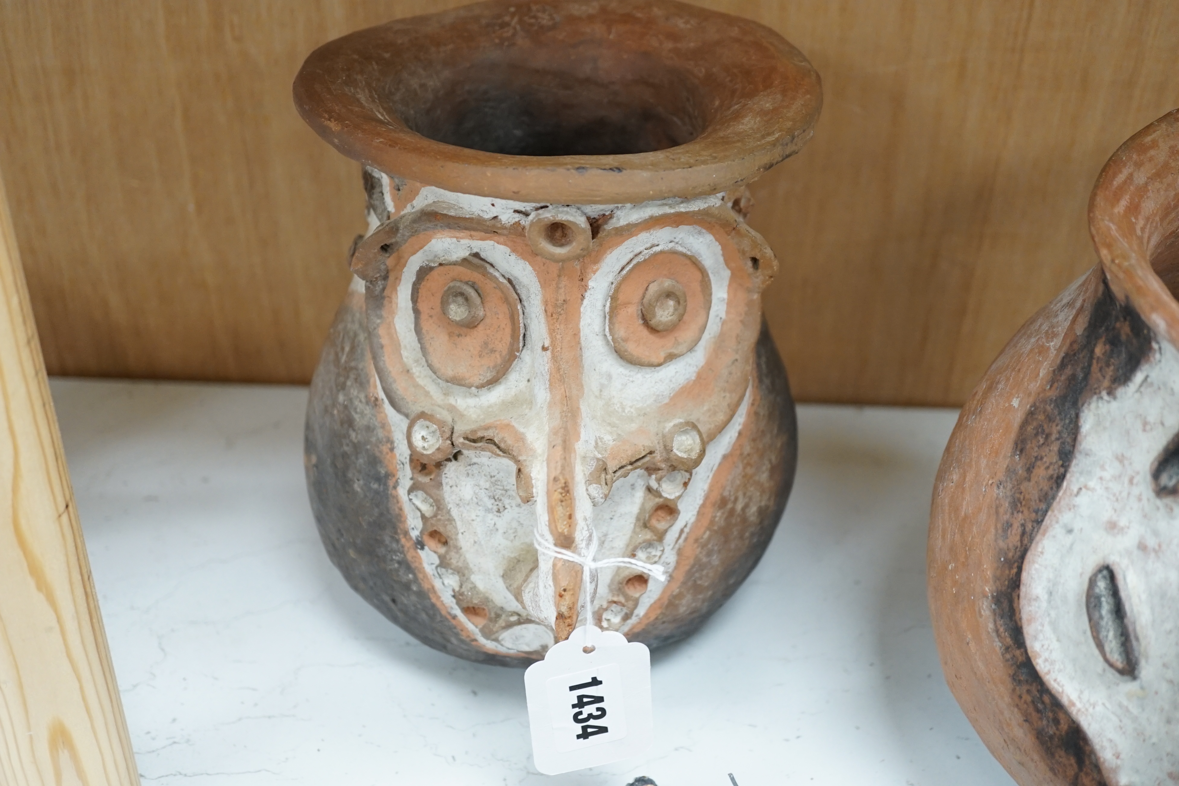 Two Papa New Guinea pottery face masks and two cooking pots